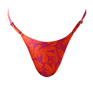Woman in a colorful bikini standing outdoors with a blurred natural background