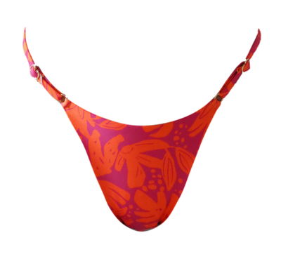 Woman in a colorful bikini standing outdoors with a blurred natural background